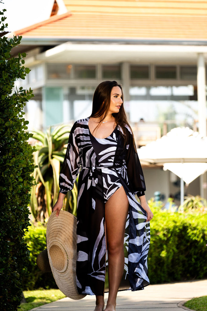 black and white one piece swimsuit with matching cover up dress